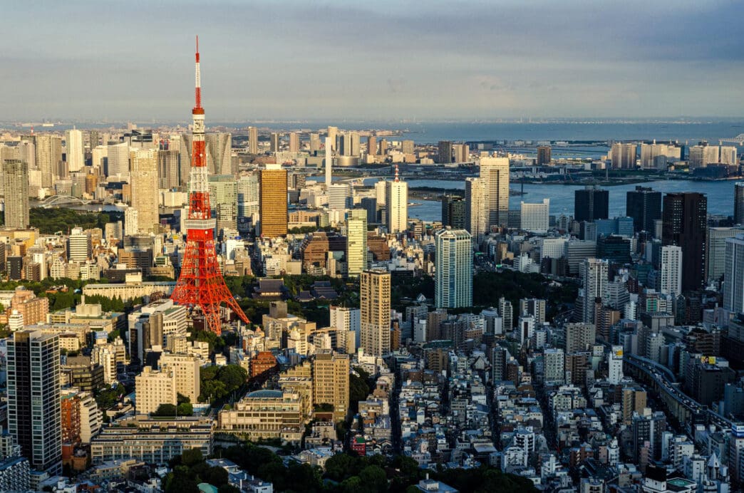 Aerial view of Tokyo cityscape featuring Tokyo Tower amidst dense buildings