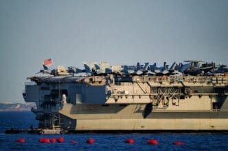 US aircraft carrier USS Gerald R Ford (CVN-78) docked in Piraeus, Greece with aircraft on deck.