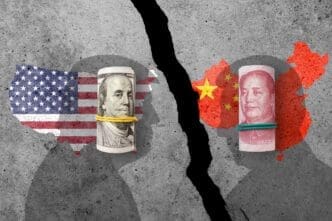 A cracked concrete wall separates rolled US dollar bills and a US map flag from rolled Chinese yuan bills and a China map flag, symbolizing trade conflict.