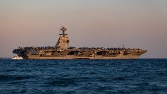 Side view of the USS Gerald R. Ford aircraft carrier anchored in Phaleron Bay, Greece.