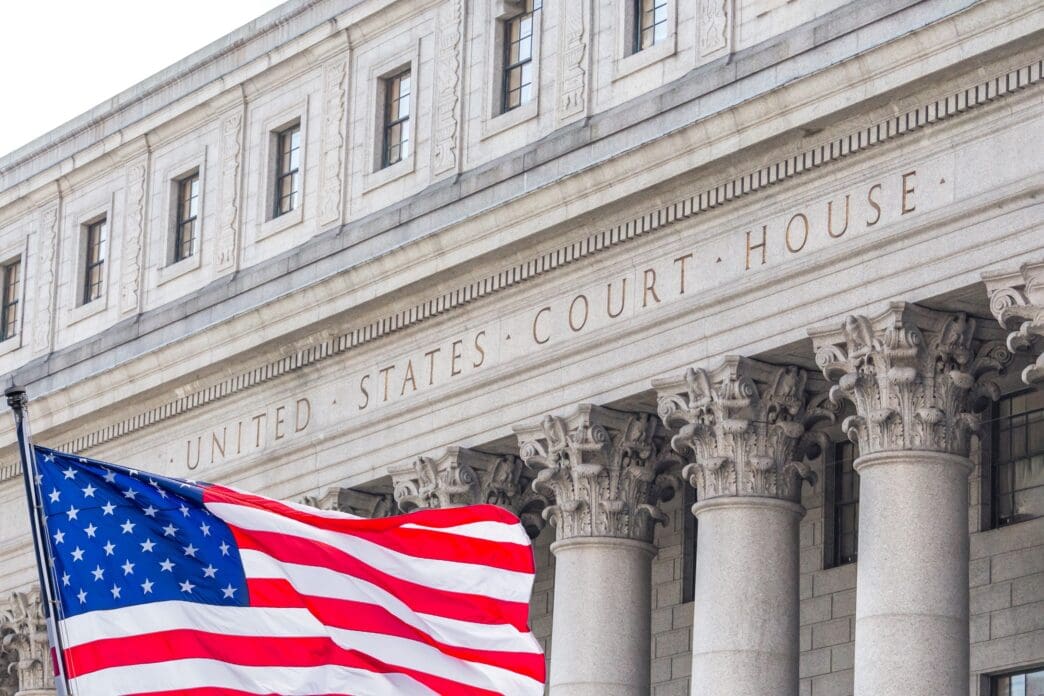 The United States Court House building with Corinthian columns and the American flag waving below it