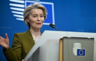 European Commission President Ursula von der Leyen speaks at a press conference with the EU flag visible
