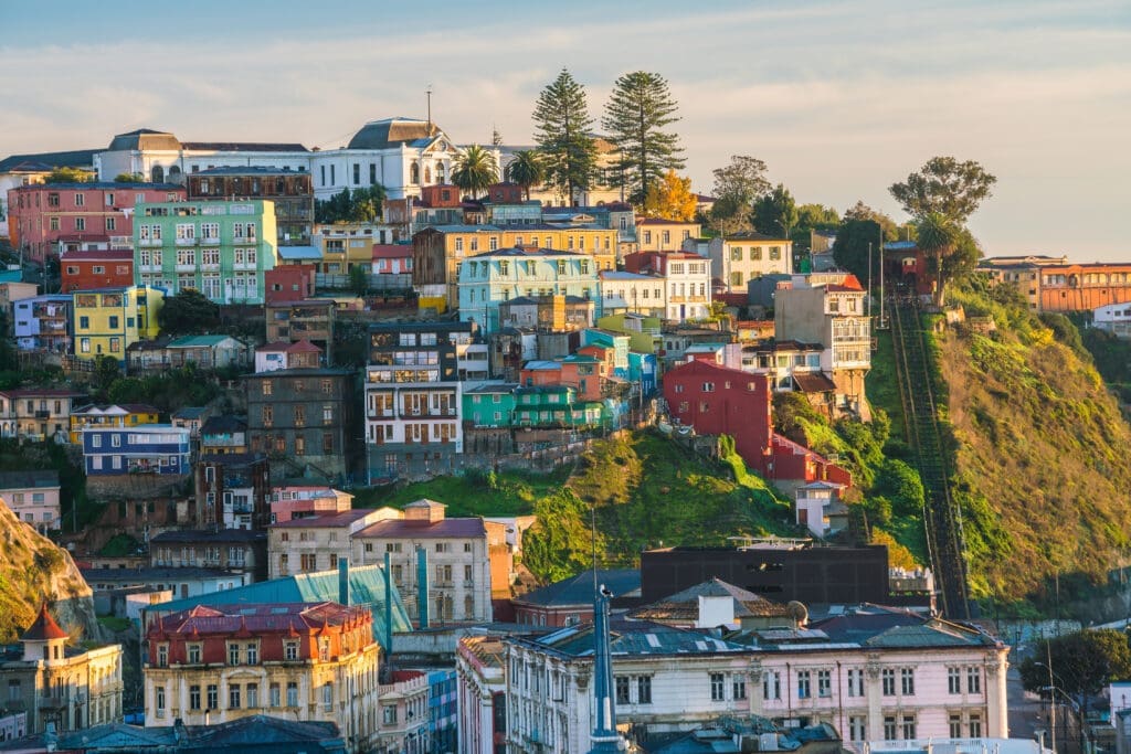 Panoramic view of the colorful, densely packed houses and historic funiculars clinging to the steep hillsides of Valparaíso, Chile