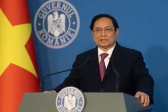 Vietnam's Prime Minister, Pham Minh Chinh, speaks at a podium in Bucharest, Romania.