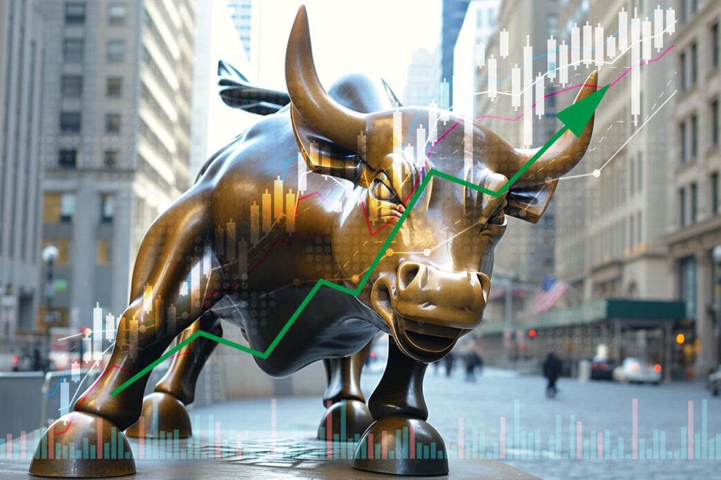 The Wall Street Charging Bull statue with a green stock market chart arrow pointing up, symbolizing a bull market.