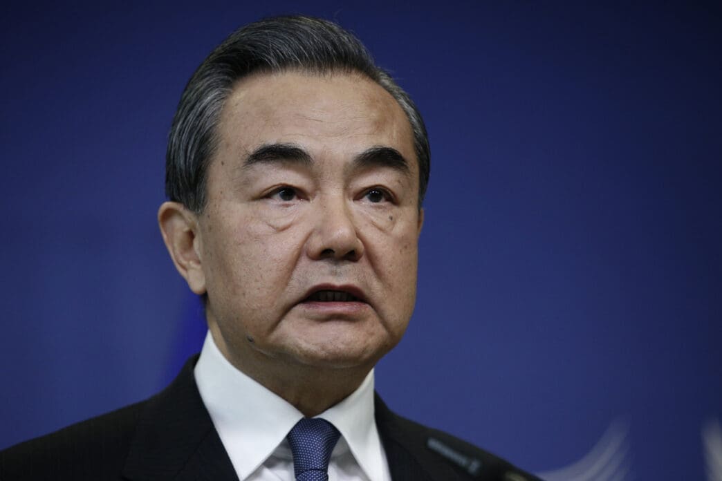 A close-up of Chinese Foreign Minister Wang Yi speaking at a press conference.
