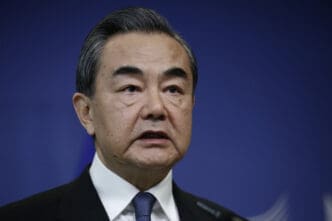 A close-up of Chinese Foreign Minister Wang Yi speaking at a press conference.