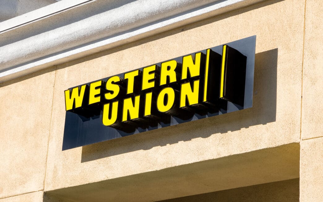 The bright yellow Western Union sign mounted on the exterior wall of a building.