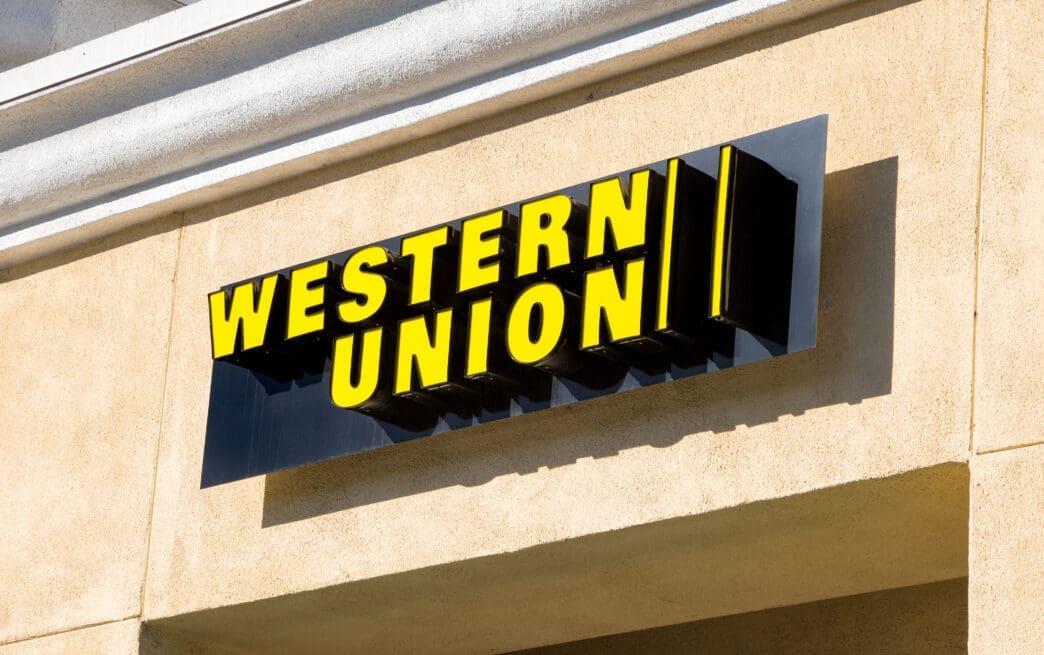 The bright yellow Western Union sign mounted on the exterior wall of a building.