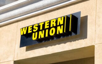 The bright yellow Western Union sign mounted on the exterior wall of a building.