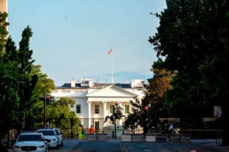 The White House seen from Lafayette Square with barriers and police after protests.
