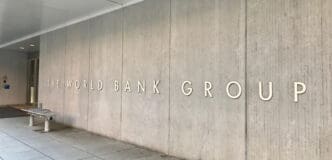 Exterior wall of the World Bank Group headquarters in Washington DC with the institution's name carved into the concrete facade.