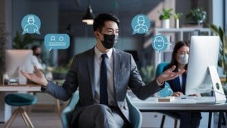 A businessman in Asia practices social distancing, looking at the camera while working in a new normal environment to prevent the spread of a virus.