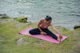 An Asian girl in a sports bra stretches her muscles.