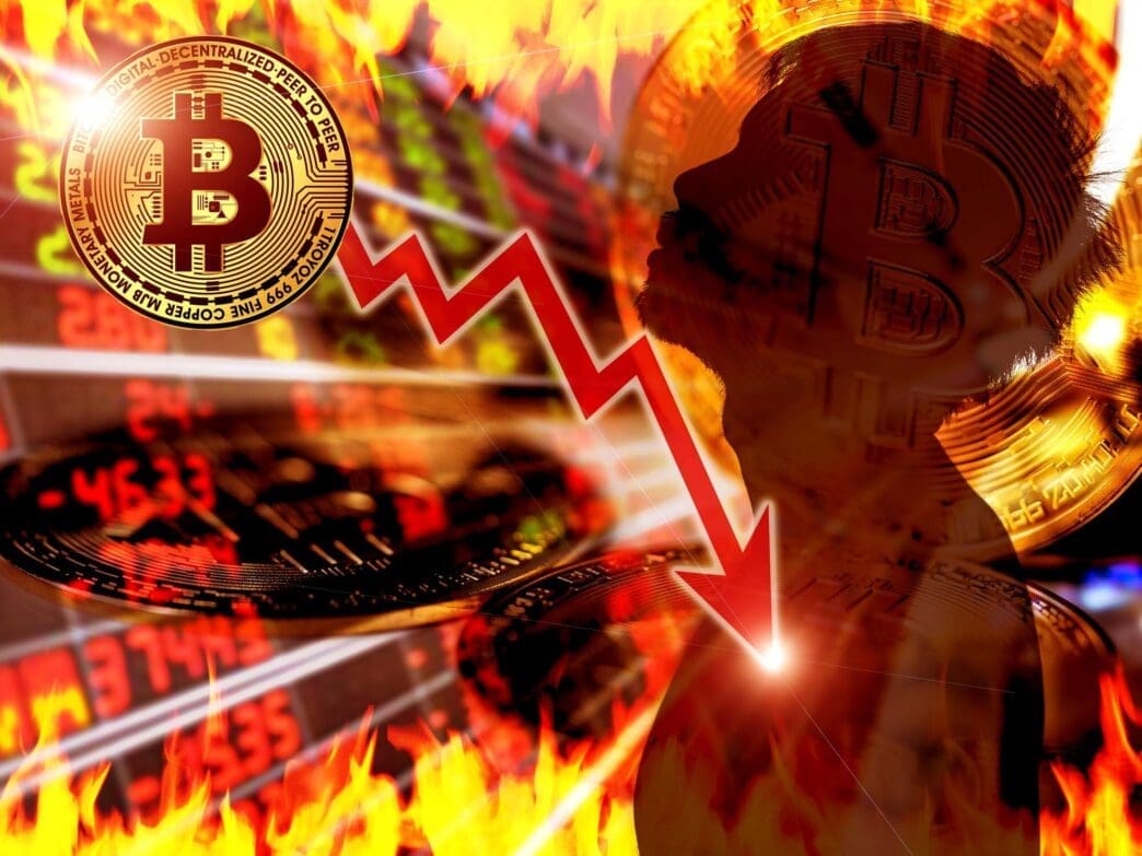 A graph depicts the declining value of Bitcoin.