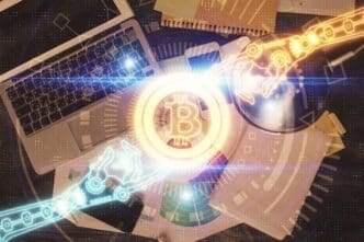 A top-down view shows a computer with holographic blockchain-themed drawings superimposed over the screen and desktop.