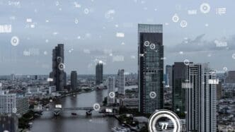 A digital interface displaying business data analytics hovers over a futuristic smart city.