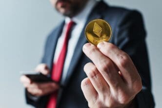 A businessman uses a mobile app on his smartphone to mine Ethereum.