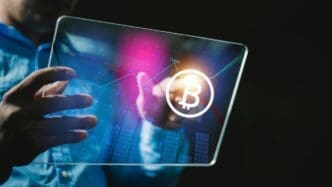 A businessman uses a tablet to connect to a global network, with a gold Bitcoin coin in flames, symbolizing growth.