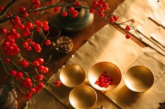 A table is decorated for Chinese New Year with red and gold decorations, including lanterns and traditional symbols.