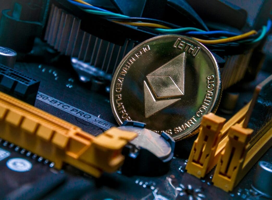 Close-up of a physical Bitcoin cryptocurrency symbol on a computer motherboard.