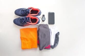 Close-up shot shows a collection of personal accessories arranged against a stark white backdrop.