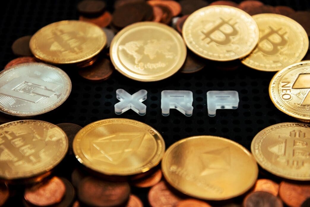 Close-up of a document with text surrounded by scattered coins on a table.