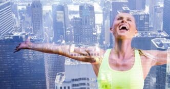 A smiling, light-skinned woman with outstretched arms stands in front of a modern cityscape.