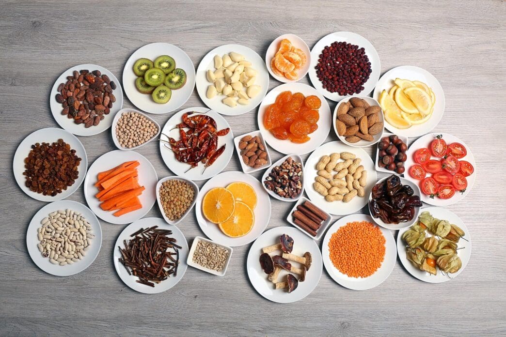 Overhead view shows various products, such as cups and small dishes, on saucers arranged on a wooden table.