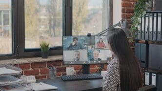 Woman in a video call with colleagues, likely for a business meeting or remote work.