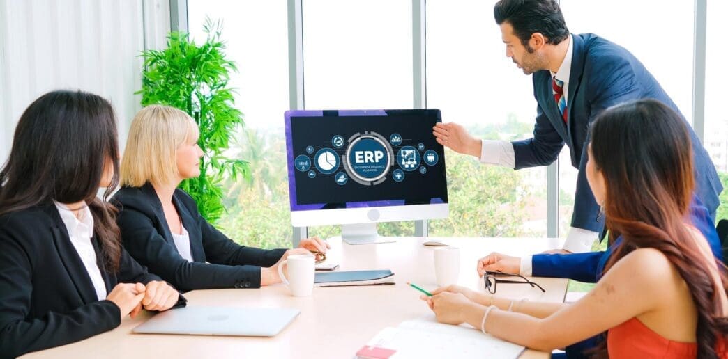 A graphic depicts a modern business environment with interconnected elements representing enterprise resource planning (ERP) software.