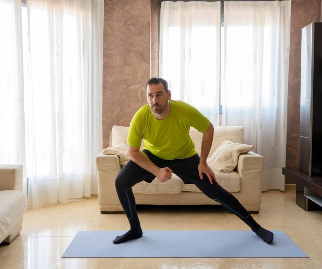 A man sits in a comfortable chair at home.