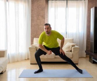 A man sits in a comfortable chair at home.