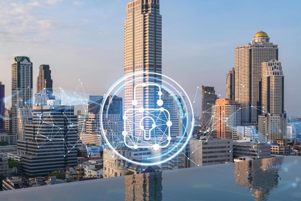 Holographic padlock overlaid on a multi-exposure image of a sunset panoramic cityscape of Bangkok, representing cybersecurity intelligence.
