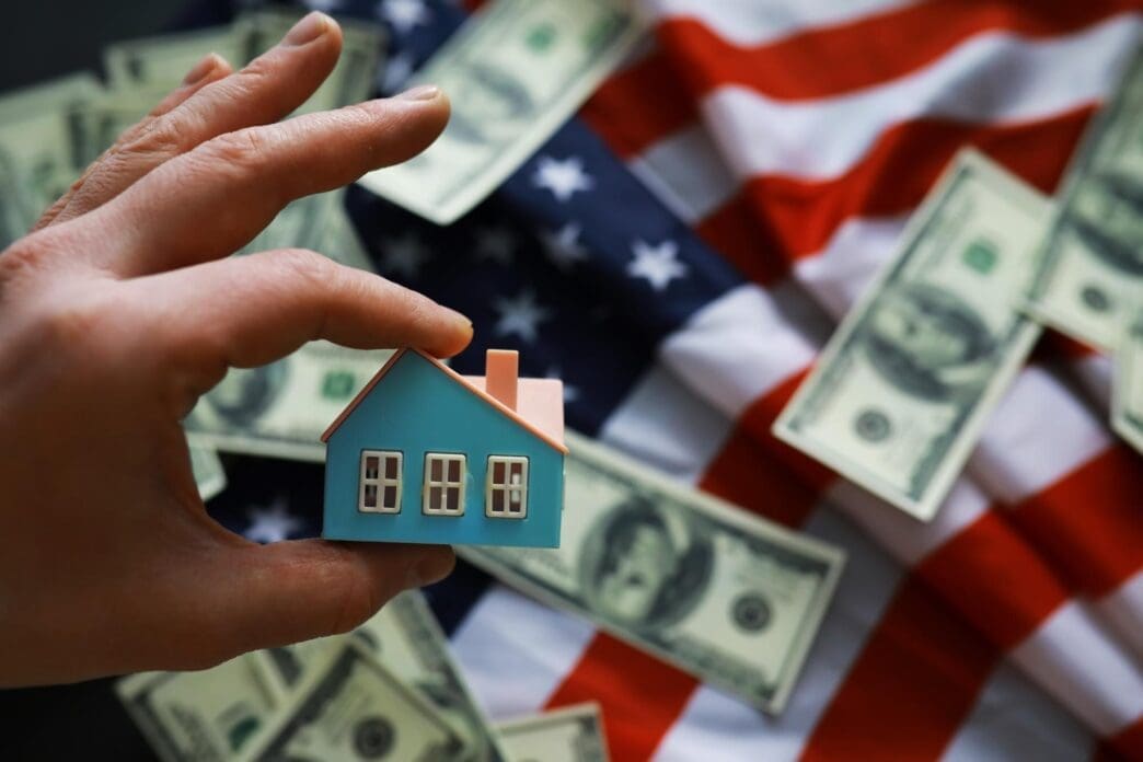 A house symbol is superimposed on an American flag, representing mortgage credit, lending, and housing safety.