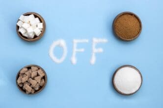 A close-up of a table displays various cups, likely containing different types of sugar, highlighting elements of proper nutrition.