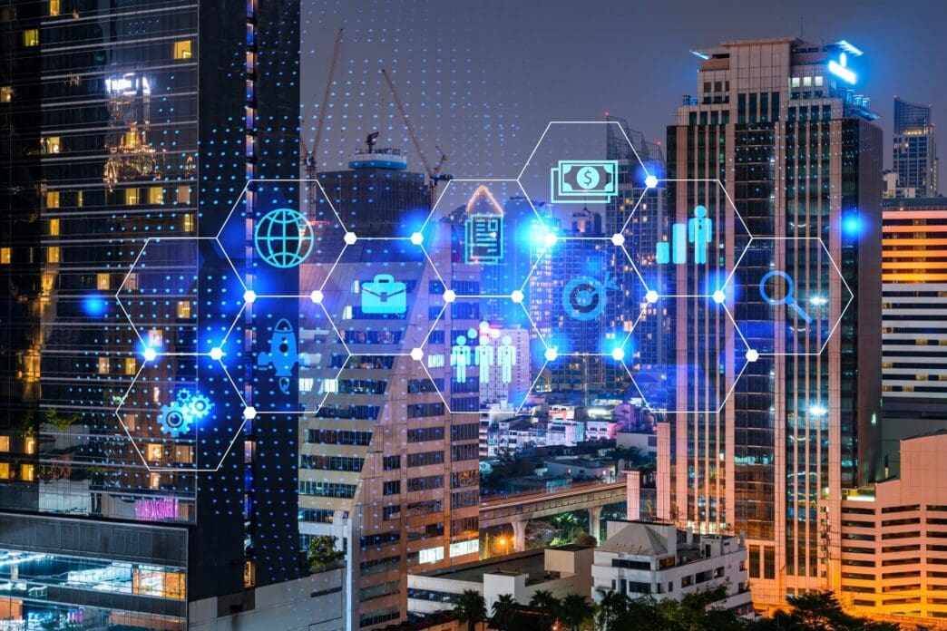 Glowing icons representing research and technological development overlaid on a panoramic night view of Bangkok, illustrating innovation and expansion.