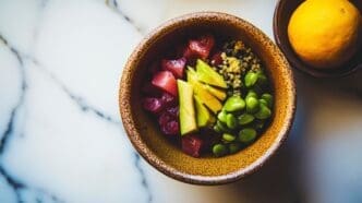 Salad Nikkei Tuna Tartare features a vibrant tuna and avocado tartare with yuzu ponzu sauce and quinoa, presenting a refined yet casual dining experience.