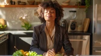 A person stands in a contemporary kitchen, bathed in soft light.