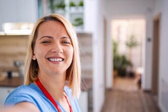 Smiling female doctor taking a selfie in a hospital setting.