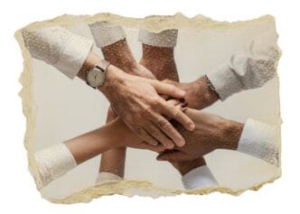 Hands of diverse people reaching toward each other, depicted as a sticker with a ripped paper effect on a transparent background.