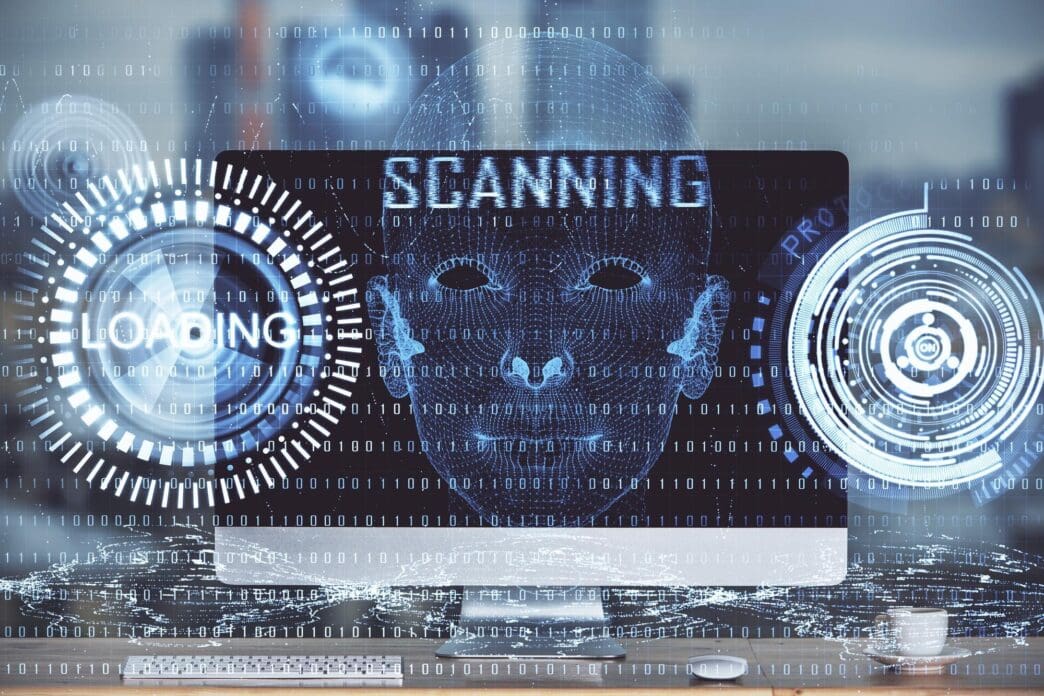 A multi-exposure image shows a workspace with a computer and overlaid technology-themed drawings, representing innovation.