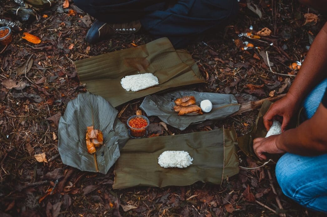 A group of tourists is eating food.