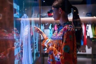 A person wearing futuristic clothing poses in front of a digital display, showcasing augmented reality fashion created with generative AI.
