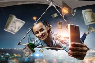 A young woman with a joyful expression soars through the air on a hang glider.