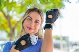 A young woman with a sporty watch smiles.