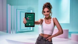 Young woman holding a tablet displaying the Spotify app.