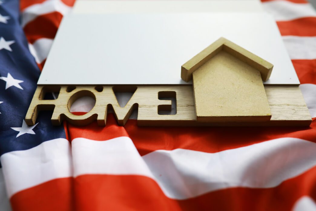 A stylized house icon is superimposed on an American flag, representing mortgage credit and housing safety.