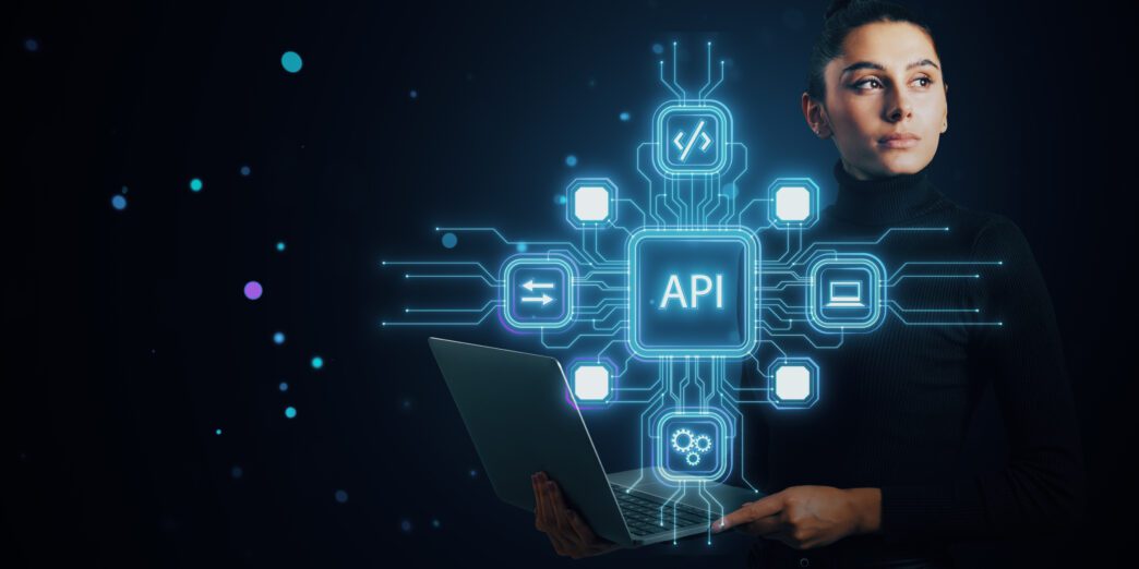 Woman holding a laptop and viewing a holographic API network interface with AI connections.