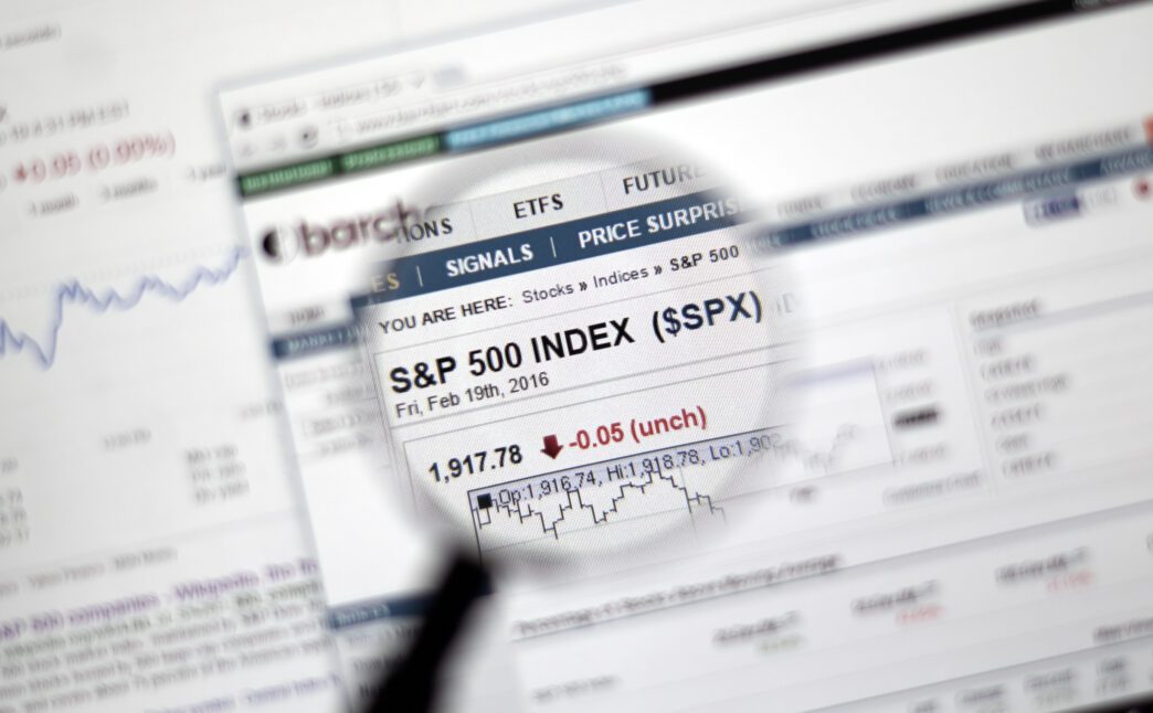 Magnifying glass focused on a web page displaying the S&P 500 index falling 0.05 points.
